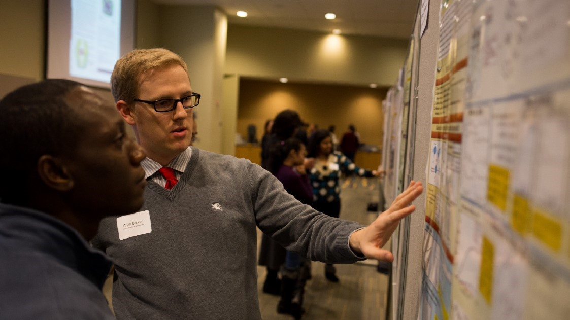 students-discuss-math-problem-while-pointing-at-whiteboard.jpg